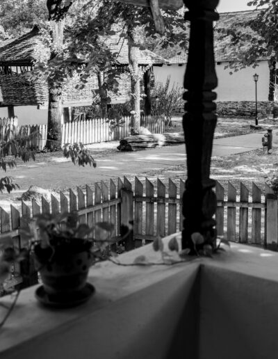 a rustic wooden fence and a view of a traditional structure in Bucharest Romania