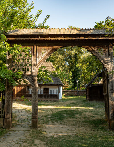 traditional gate and rural houses at the Dimitrie Gusti National Village Museum in Bucharest, Romania